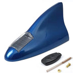 imagem mostra uma antena de tubarão para carro na cor azul e um fundo branco atrás